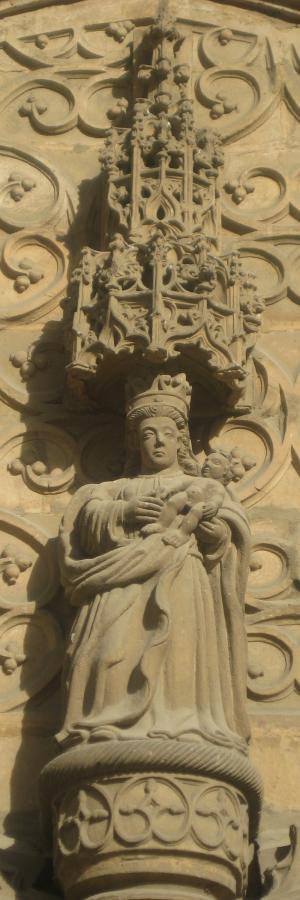 Escultura de la Virgen con el Niño en la Portada del Sol, bajo su doselete gótico